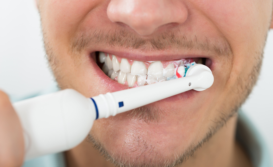 Man Teeth With Electric Toothbrush