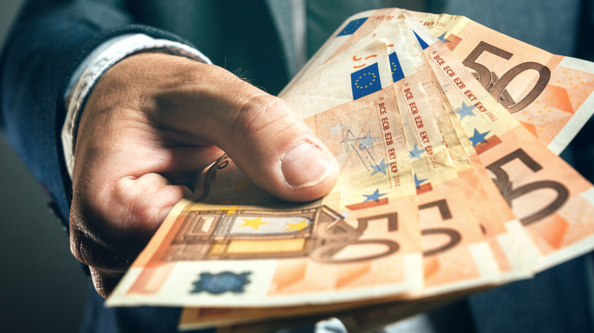 businessman-from-bank-offering-money-loan-in-euro-banknotes-picture-id531414342