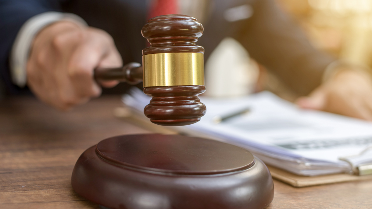 Close up lawyer businessman working or reading lawbook in office workplace for consultant lawyer concept.