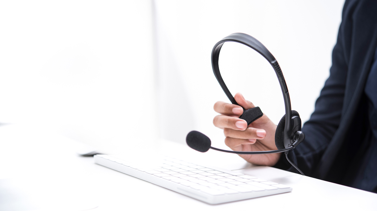 Midsection Of Businesswoman Holding Headset While Working In Office