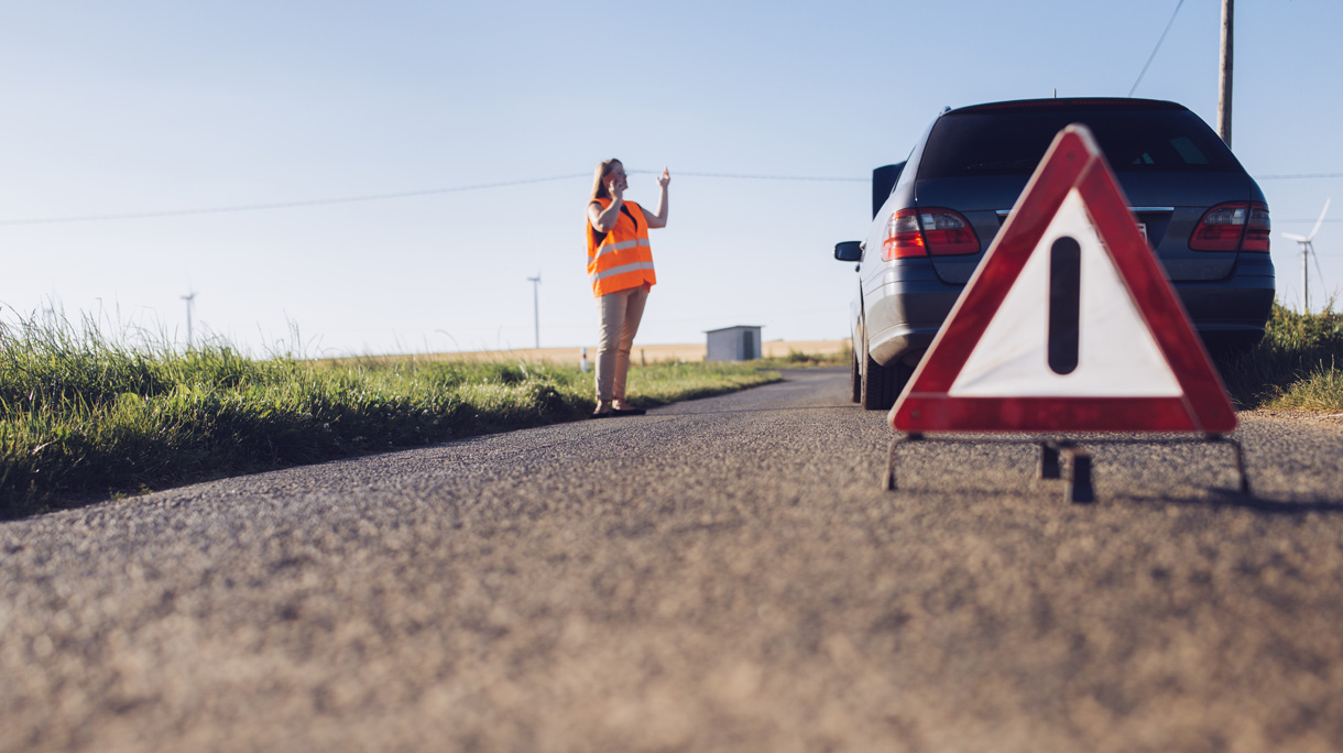 Woman phoning and car breakdown.