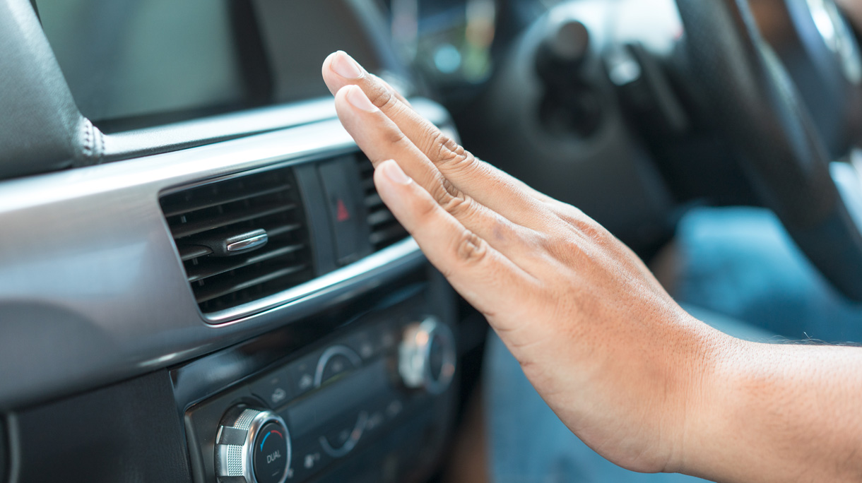 Closeup of hand checking the air conditioner in the car, The cooling system in the car