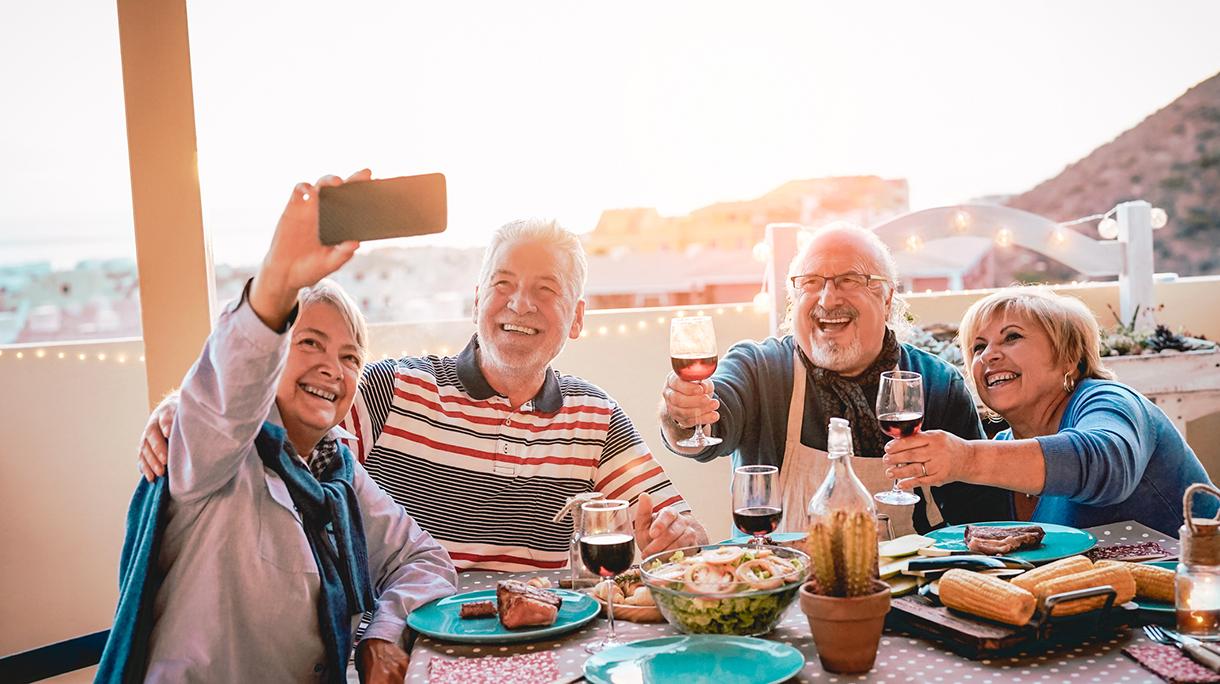 Cheerful Senior Couples Posing For Cellphone Selfie While Having Meal At Home