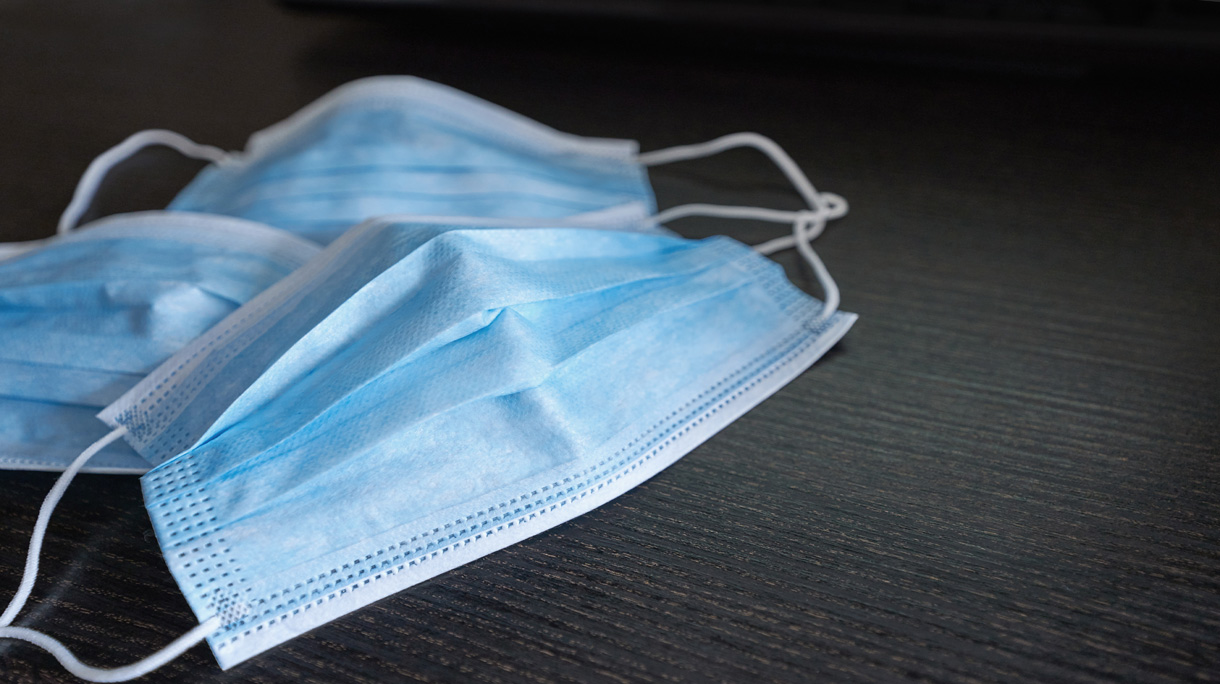 Respiratory mask on desk in office, Protective medical mask with 2019-nCoV, Coronavirus protection concept.