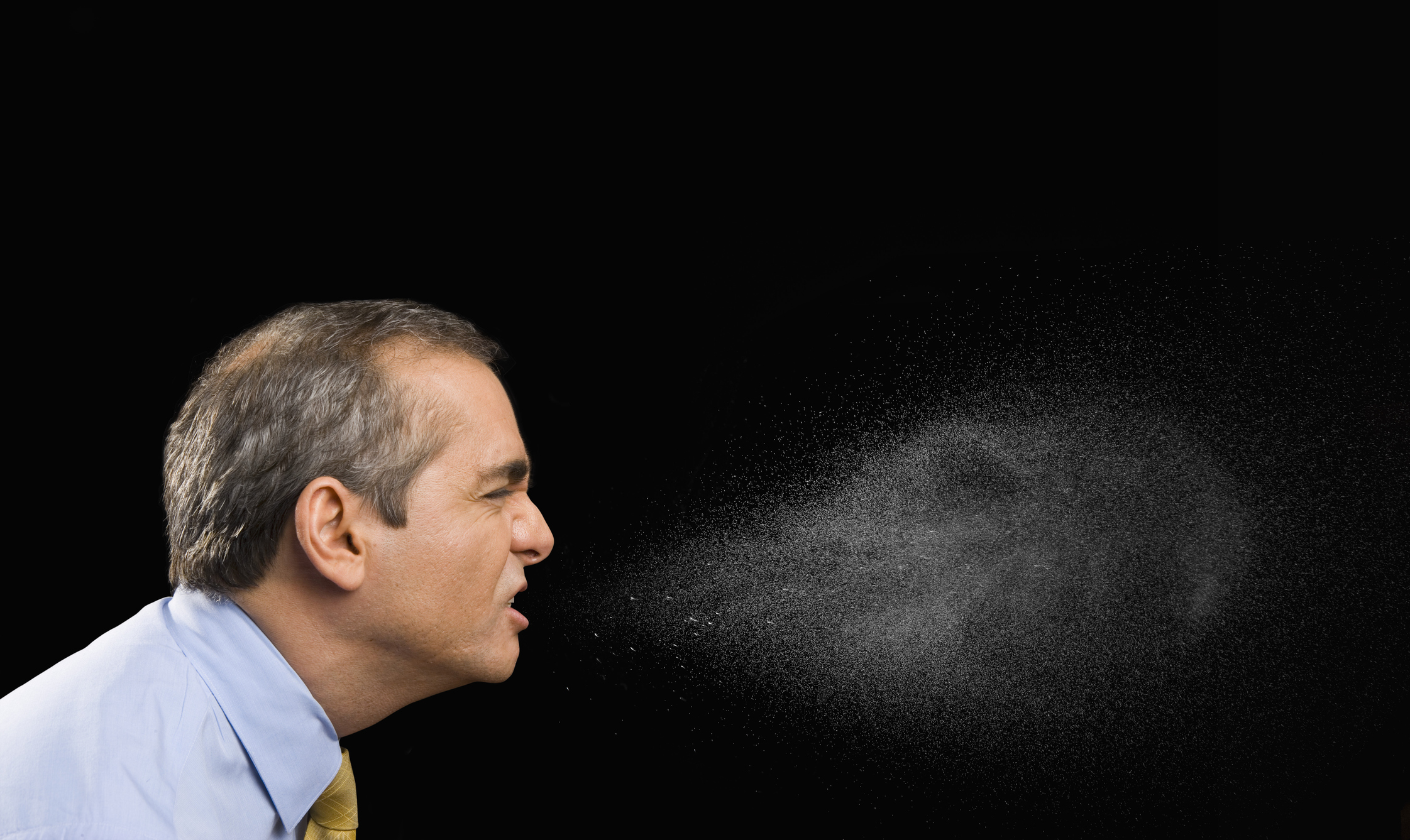 Businessman sneezing