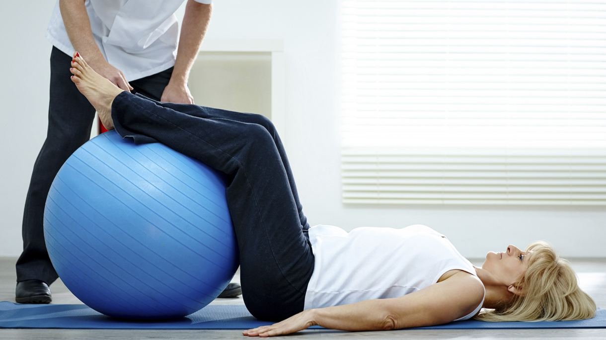 Female patient working with physical therapists pilates exercise
