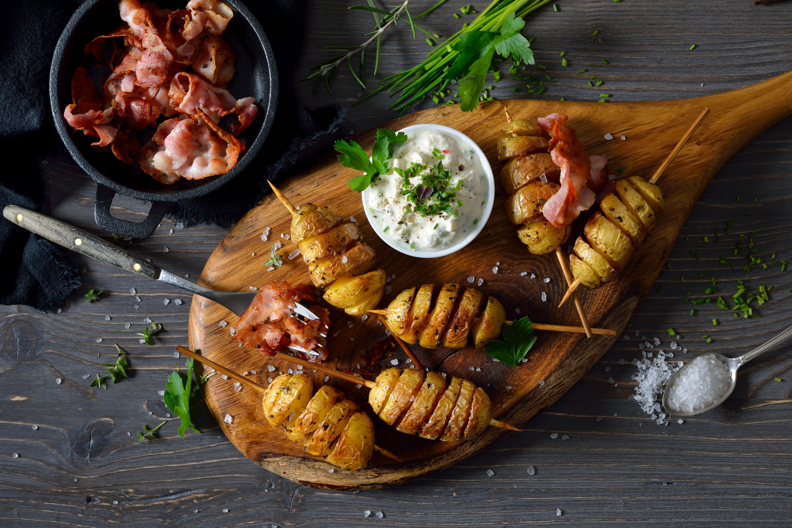 Baekd herb potato skewers with curd and bacon