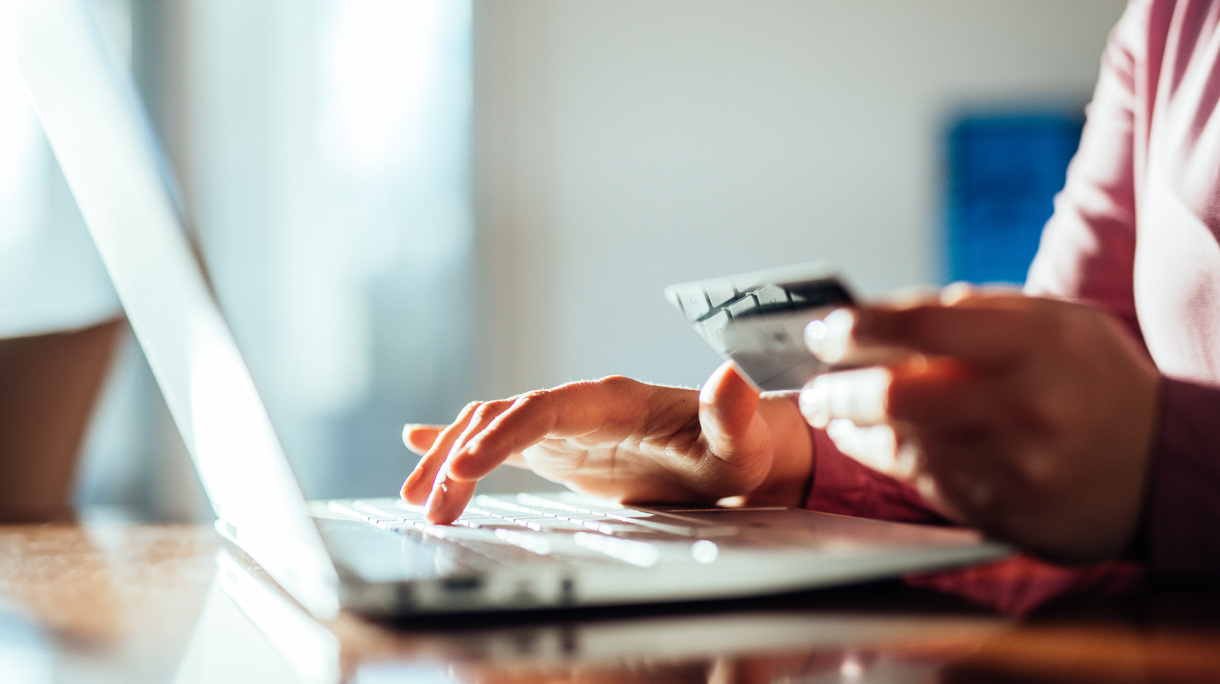 Woman shopping online with a credit card and pc.