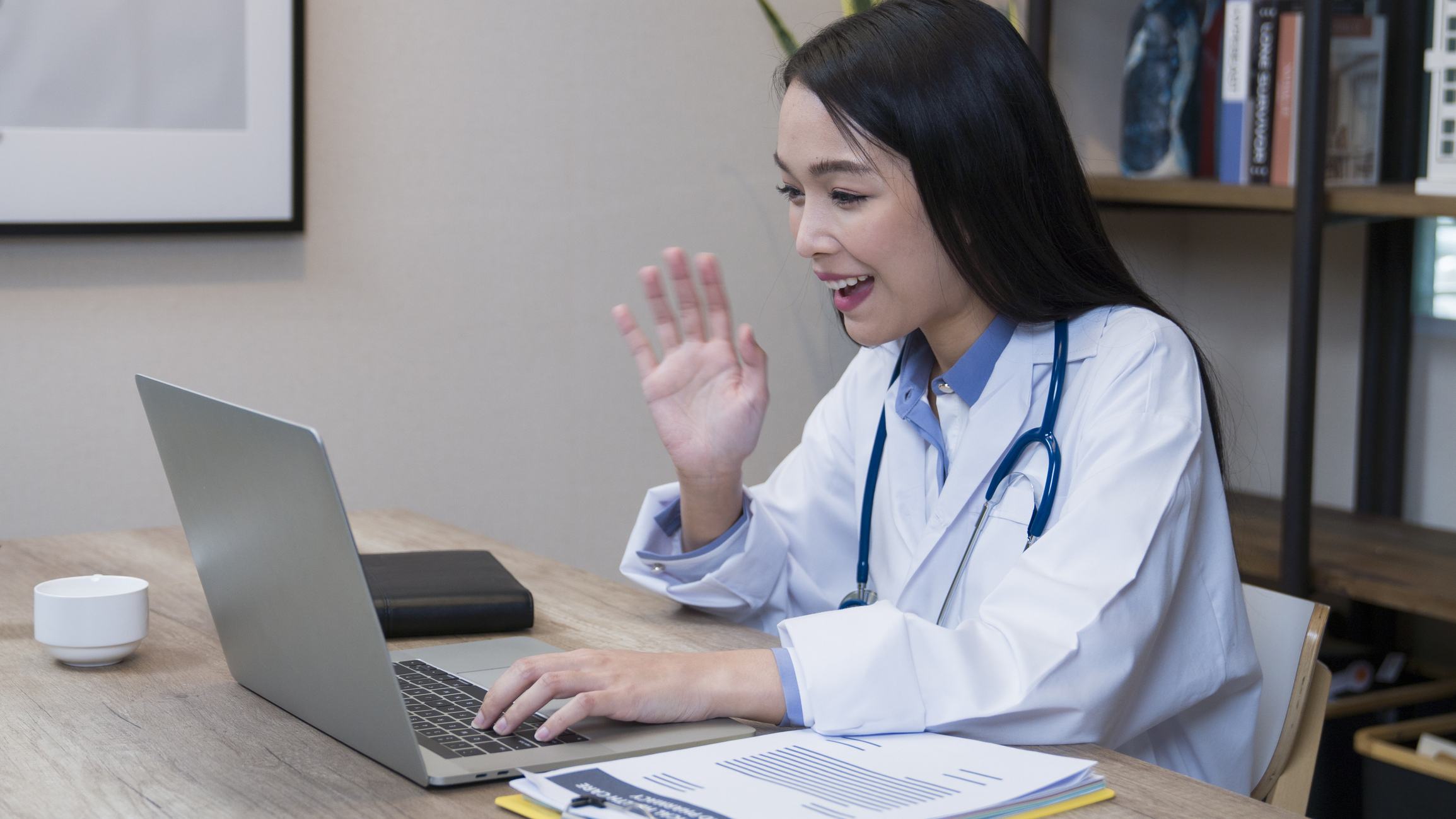 Female doctor telecommuting with patient from home office