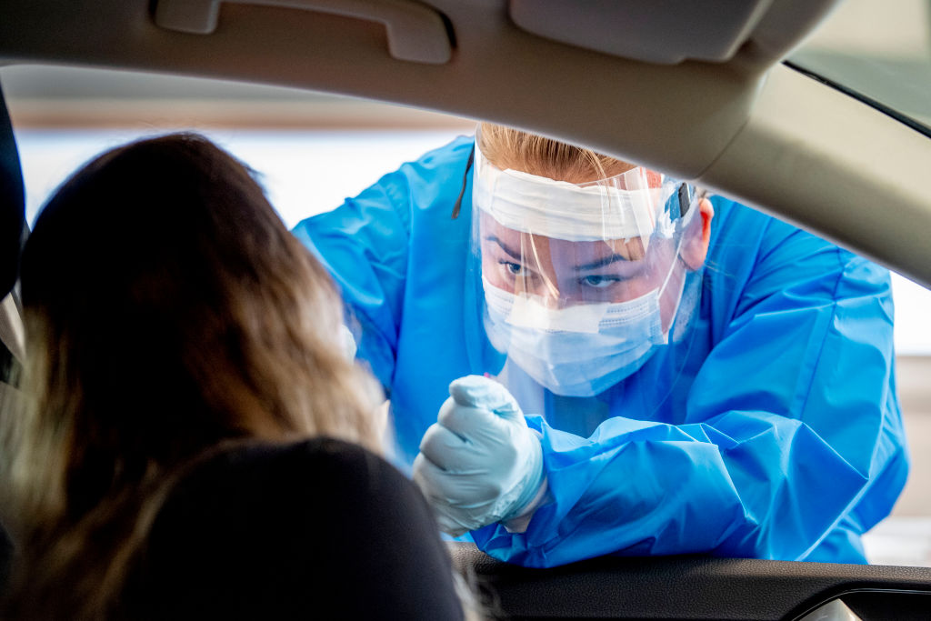 A health worker wearing a personal protective equipment suit