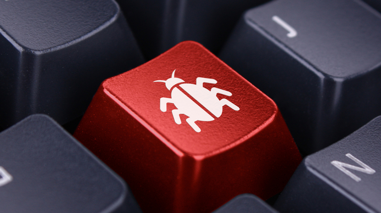 Close-up of a red computer key with a bug on it