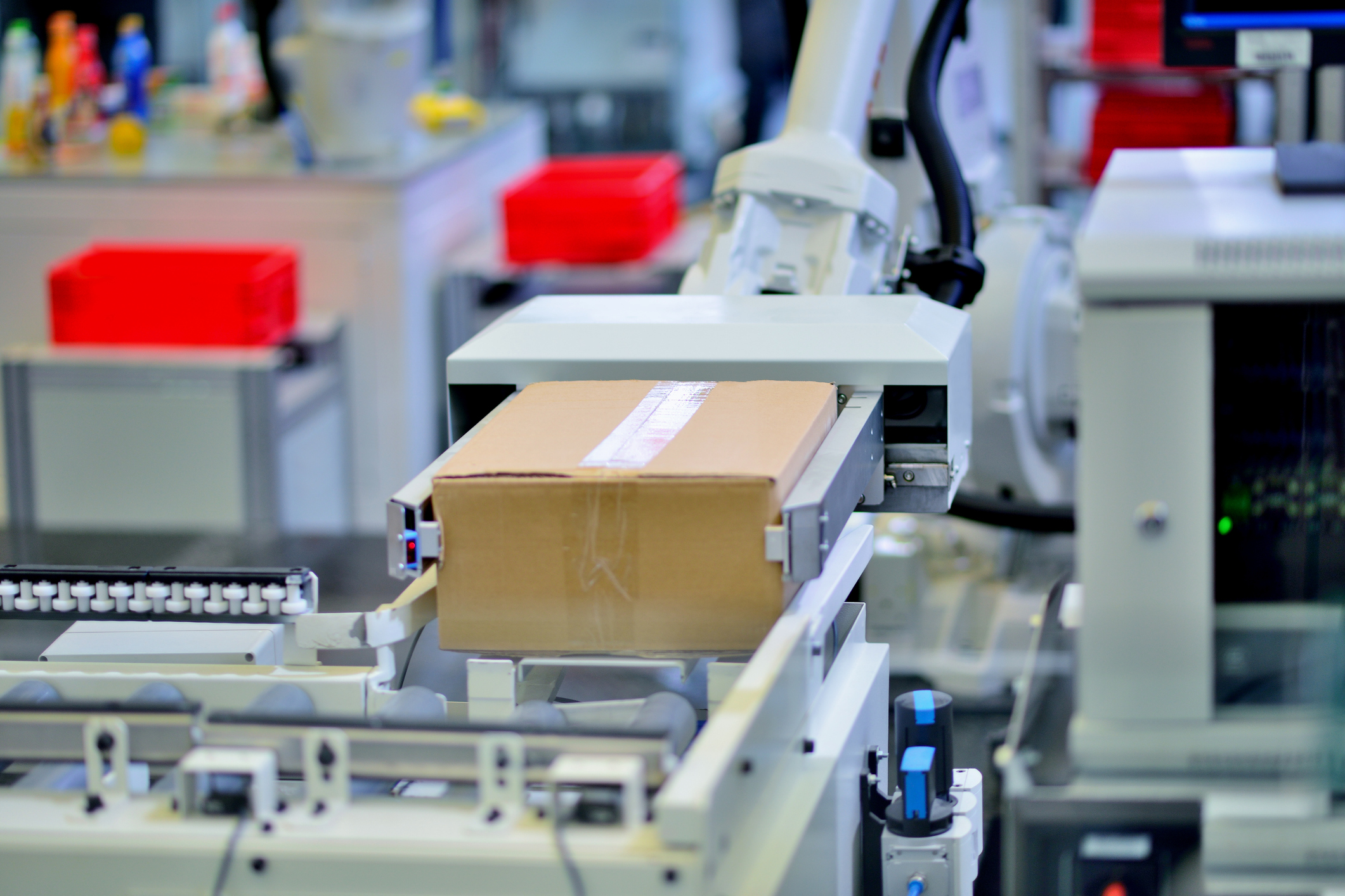 Robotic Arm Carrying Cardboard Box on Conveyor Belt