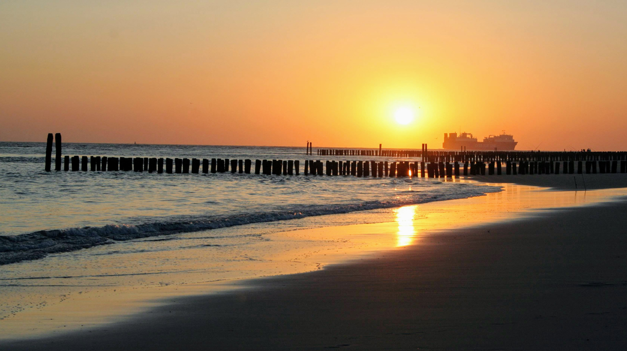 Scenic View Of Beach Against Sky During Sunset