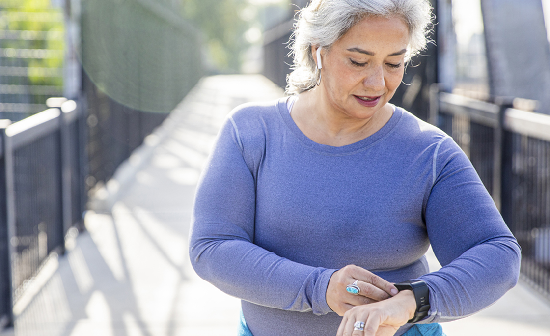 Mature Mexican Woman using fitness tracker
