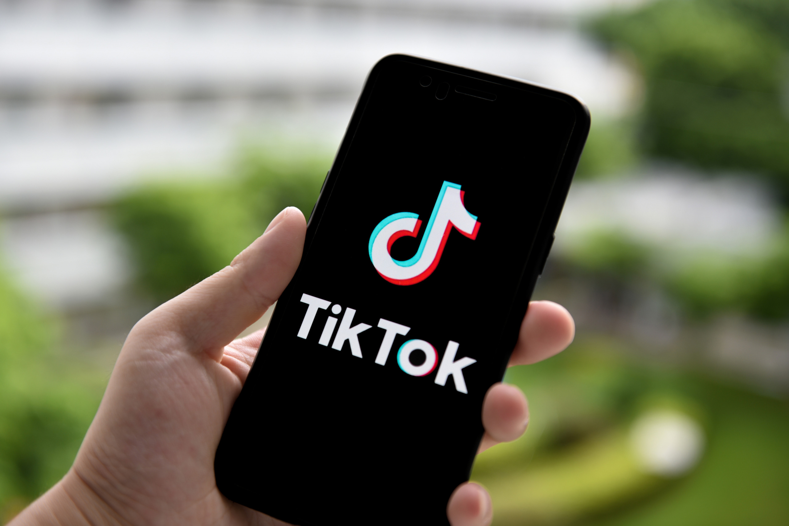 In this photo illustration a TikTok logo is seen displayed
