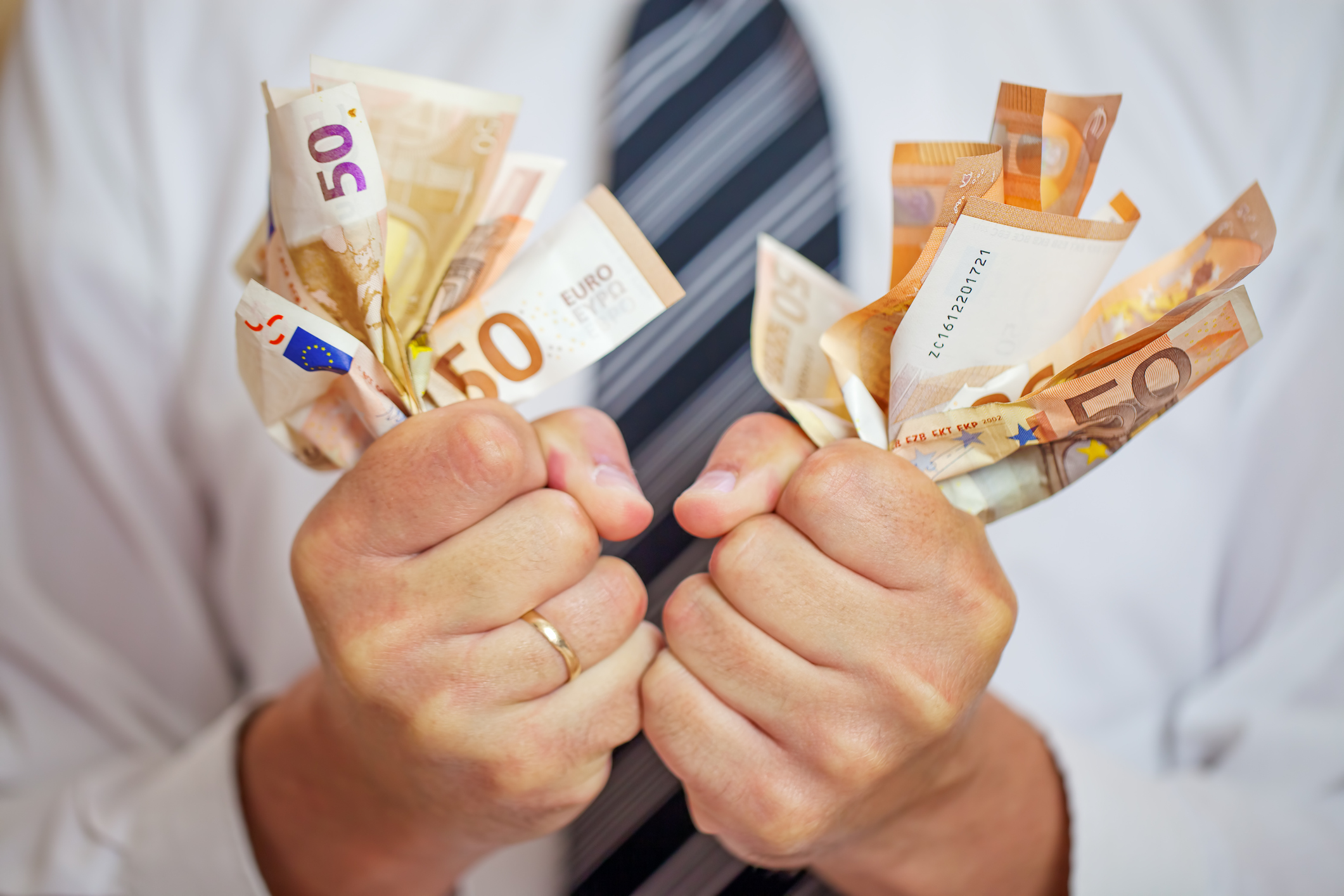 Money addicted, Greedy businessman squeezing money. Love of money.