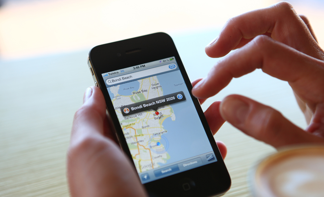 Woman Using Google Maps On Her iPhone