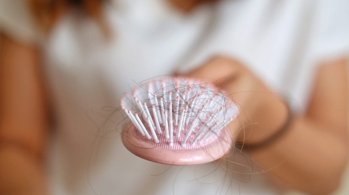Midsection Of Woman Hairbrush With Fallen Hair