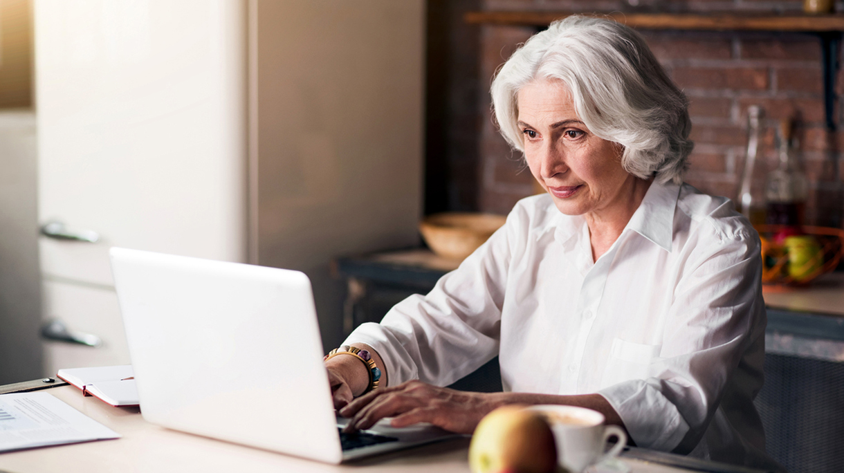 Old good-looking lady using her laptop