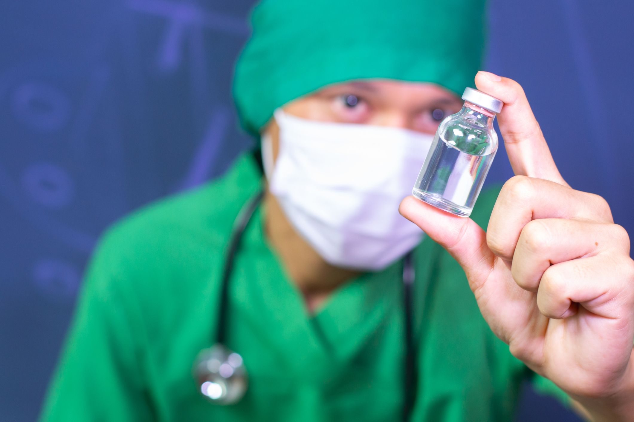 Doctor and nurse analyzing unknown MMR vaccine drug phial in medical clinic hospital