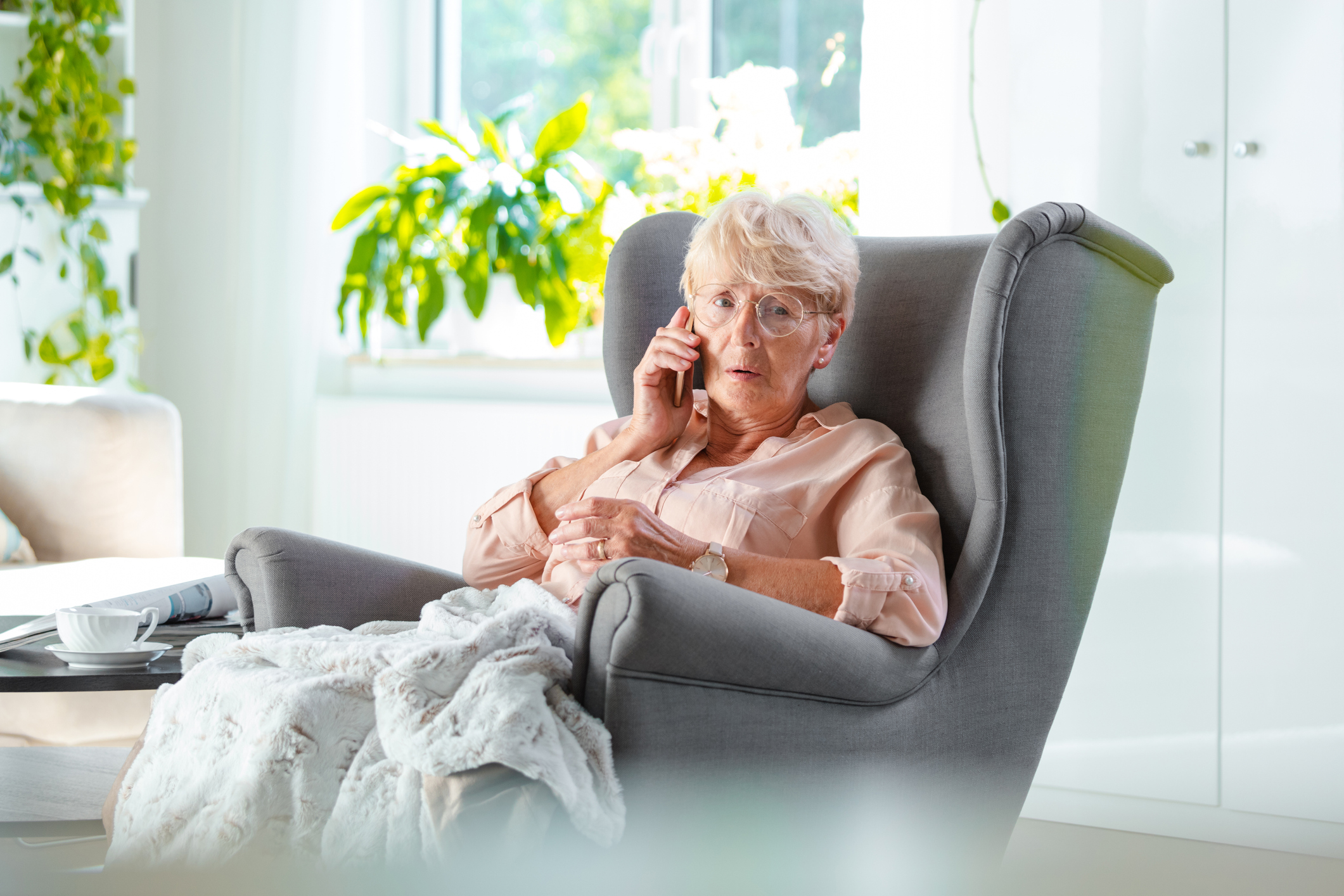 Elderly lady talking on cell phone looking worried