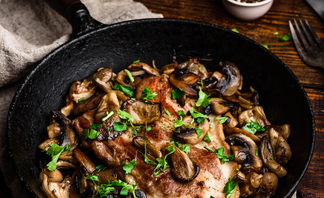 Fried pork neck steak with different mushrooms