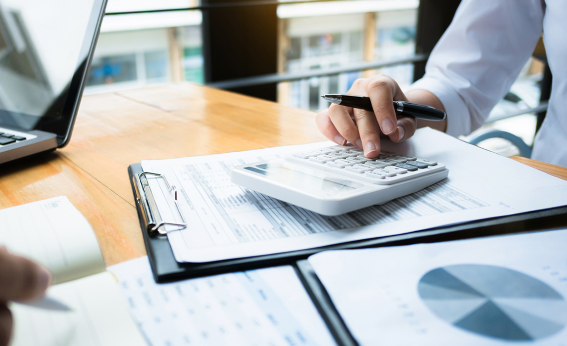 business audits using a calculator financial data investment fund at a workplace, wealth concept