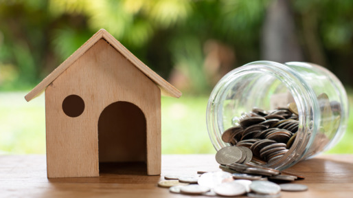Home model with coin money stack, Saving money concept. Home buying.