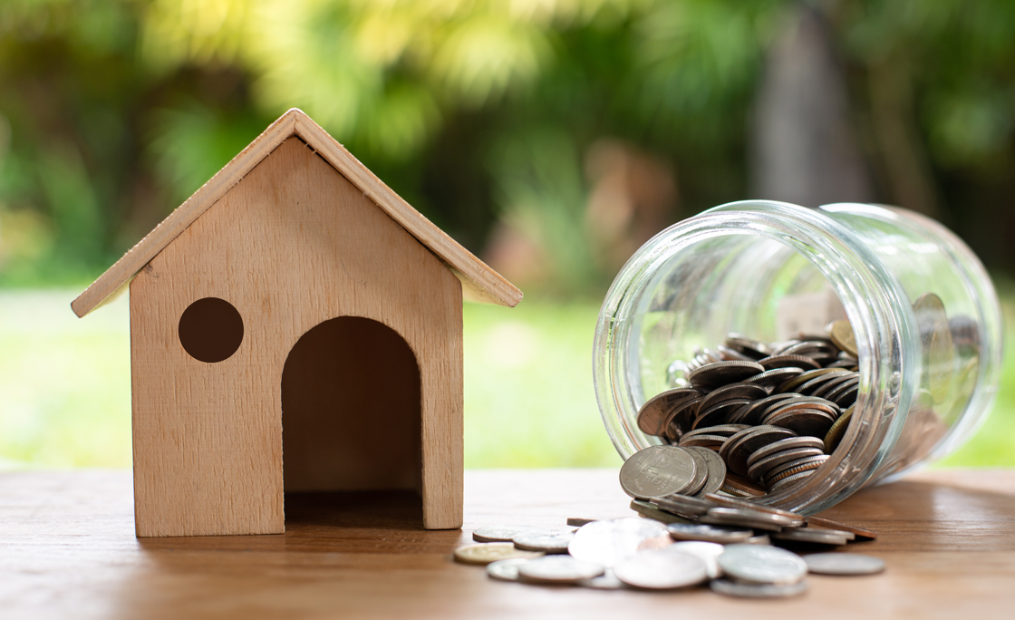 Home model with coin money stack, Saving money concept. Home buying.