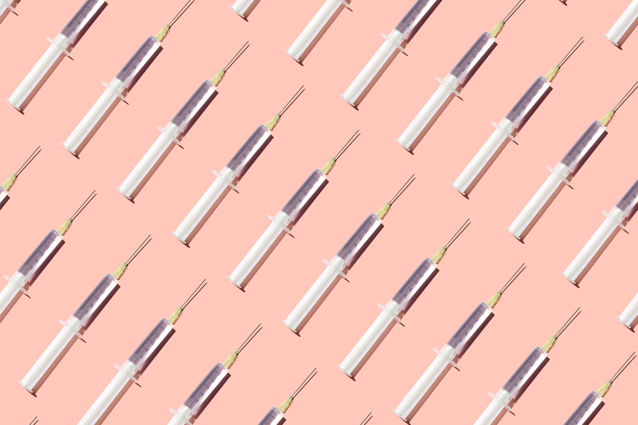 Repeated syringes on the pink background