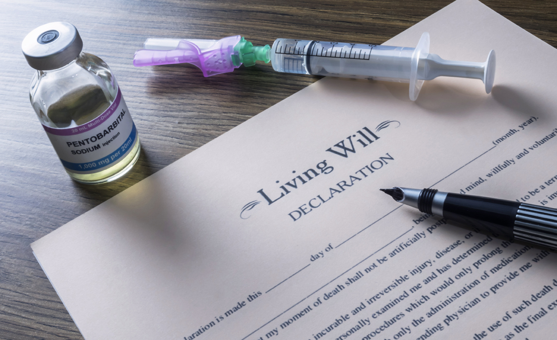 Living will declaration form Next to a vial of pentobarbital sodium to proceed to euthanasia, conceptual image