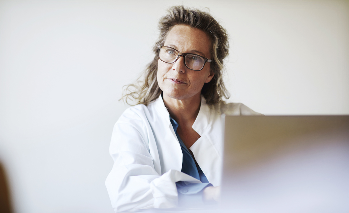 Female doctor using laptop
