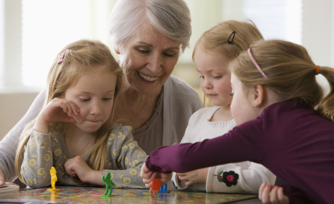 Caucasian grandmother and granddaughters playing game together