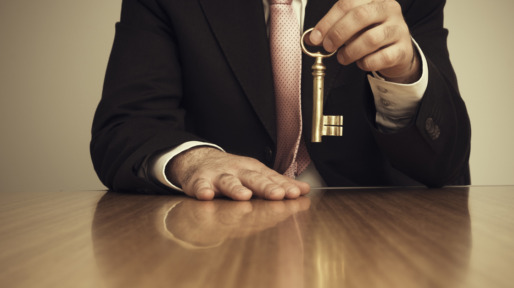 Businessman Holding Skeleton Key