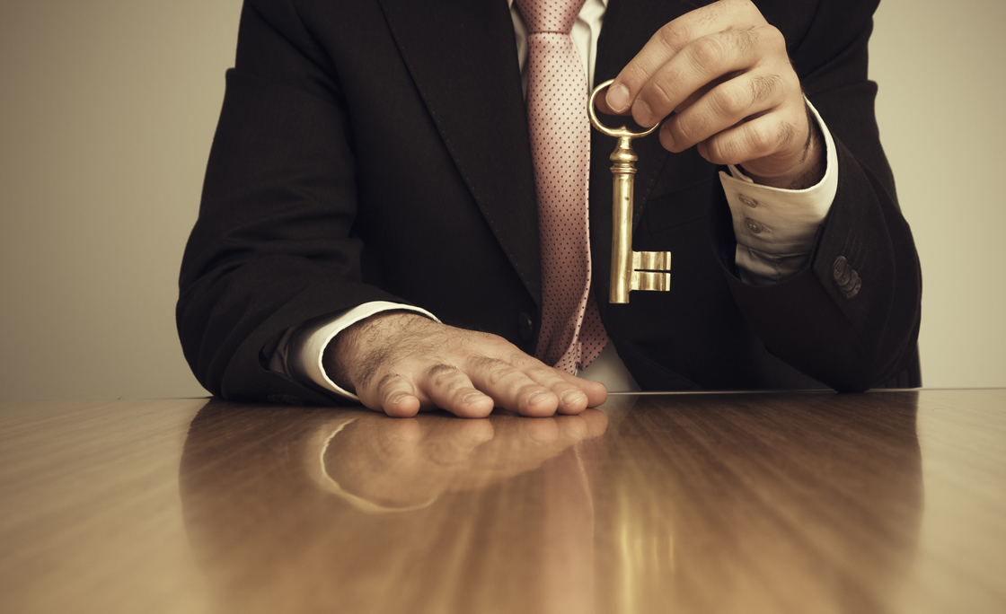 Businessman Holding Skeleton Key