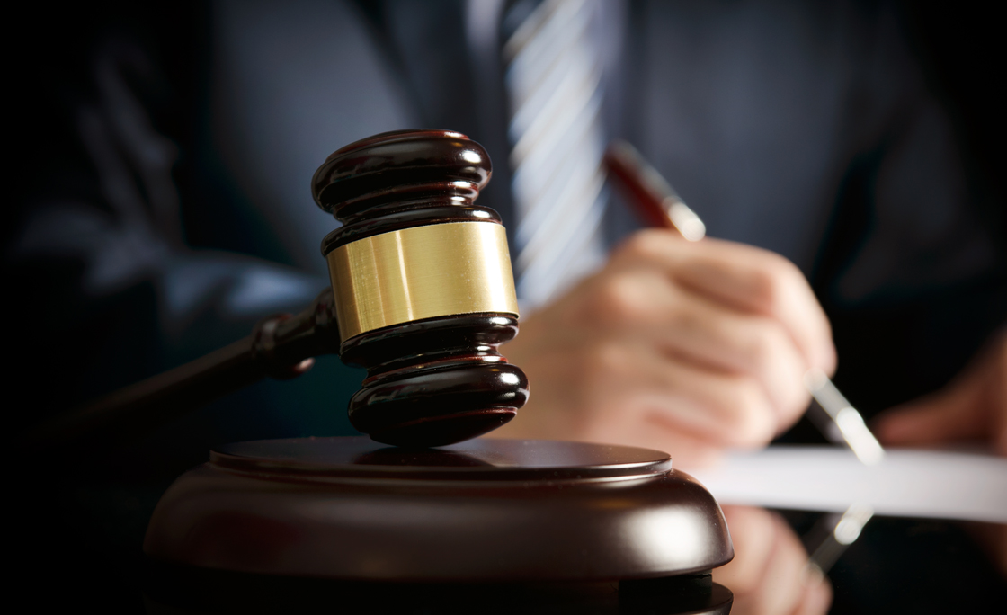 Lawyer in office with gavel, symbol of justice