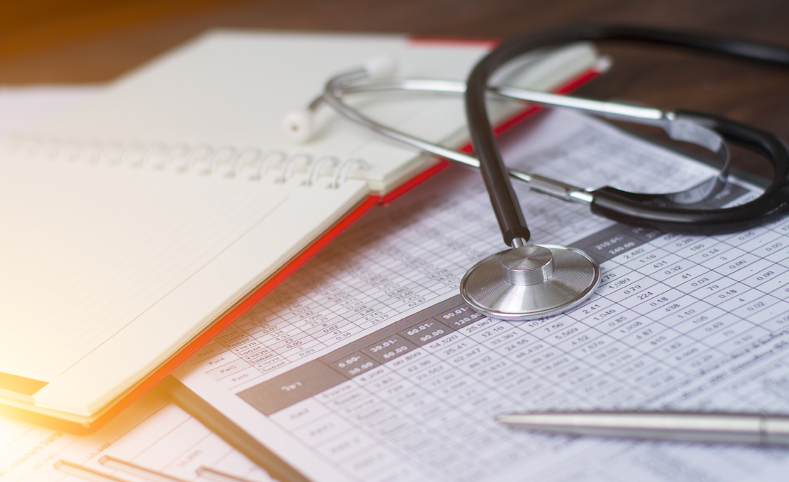 Health care costs. Stethoscope and calculator symbol