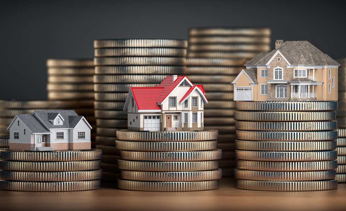 Houses of different size with different value on stacks of coins. Concept of  property, mortgage and real estate investment.