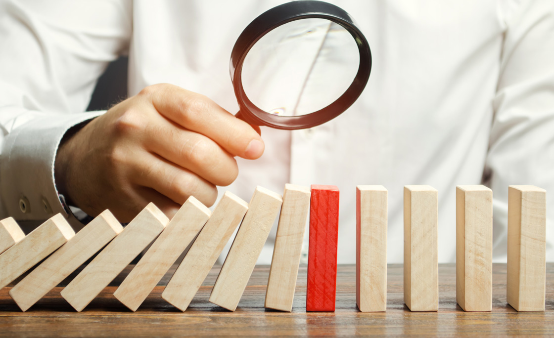Businessman looks on collapse domino effect. Stress resistance business. Financial stability. Recovery business. Evaluation of cash risks. Creating a strategy. Management and planning. Decision making