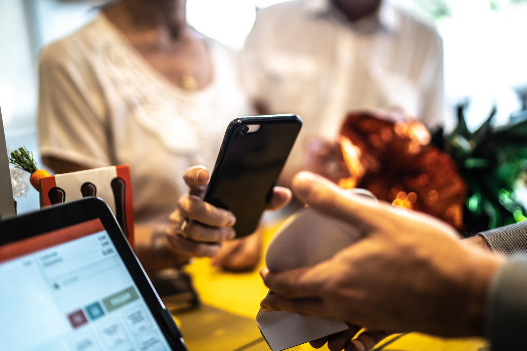 Senior woman paying by mobile in a store