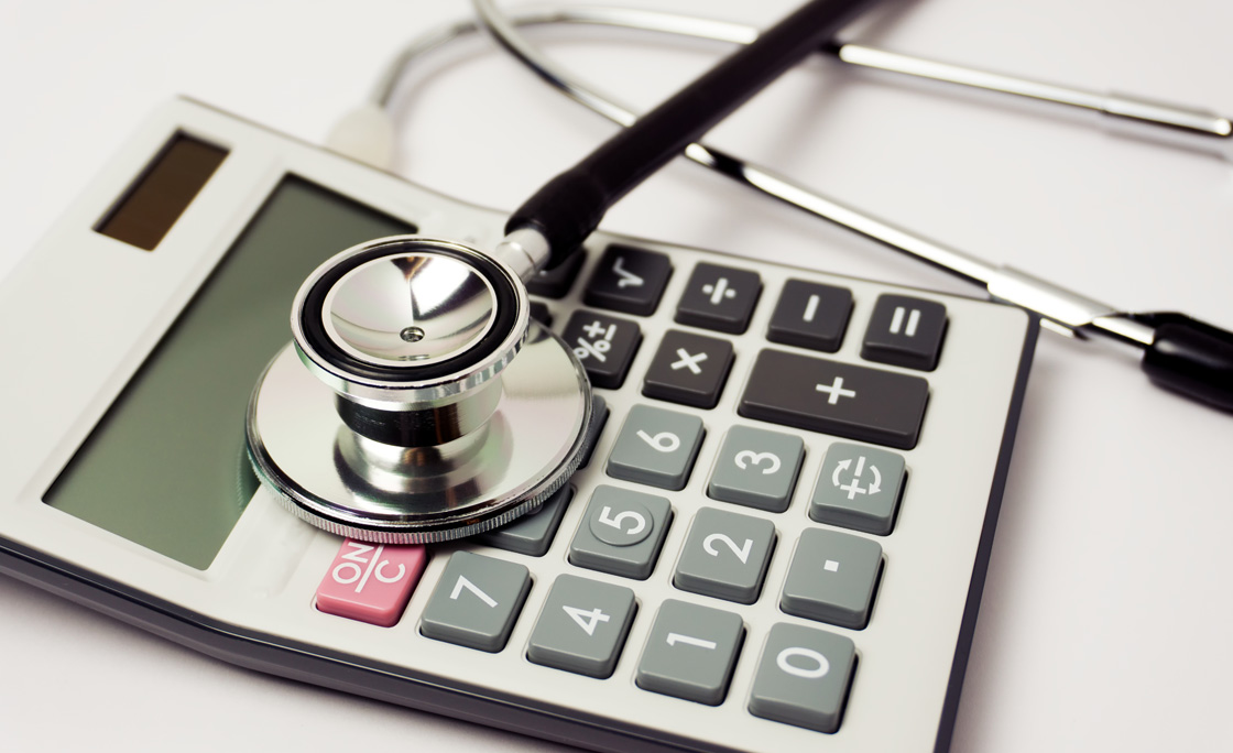 Stethoscope and Calculator on White Background