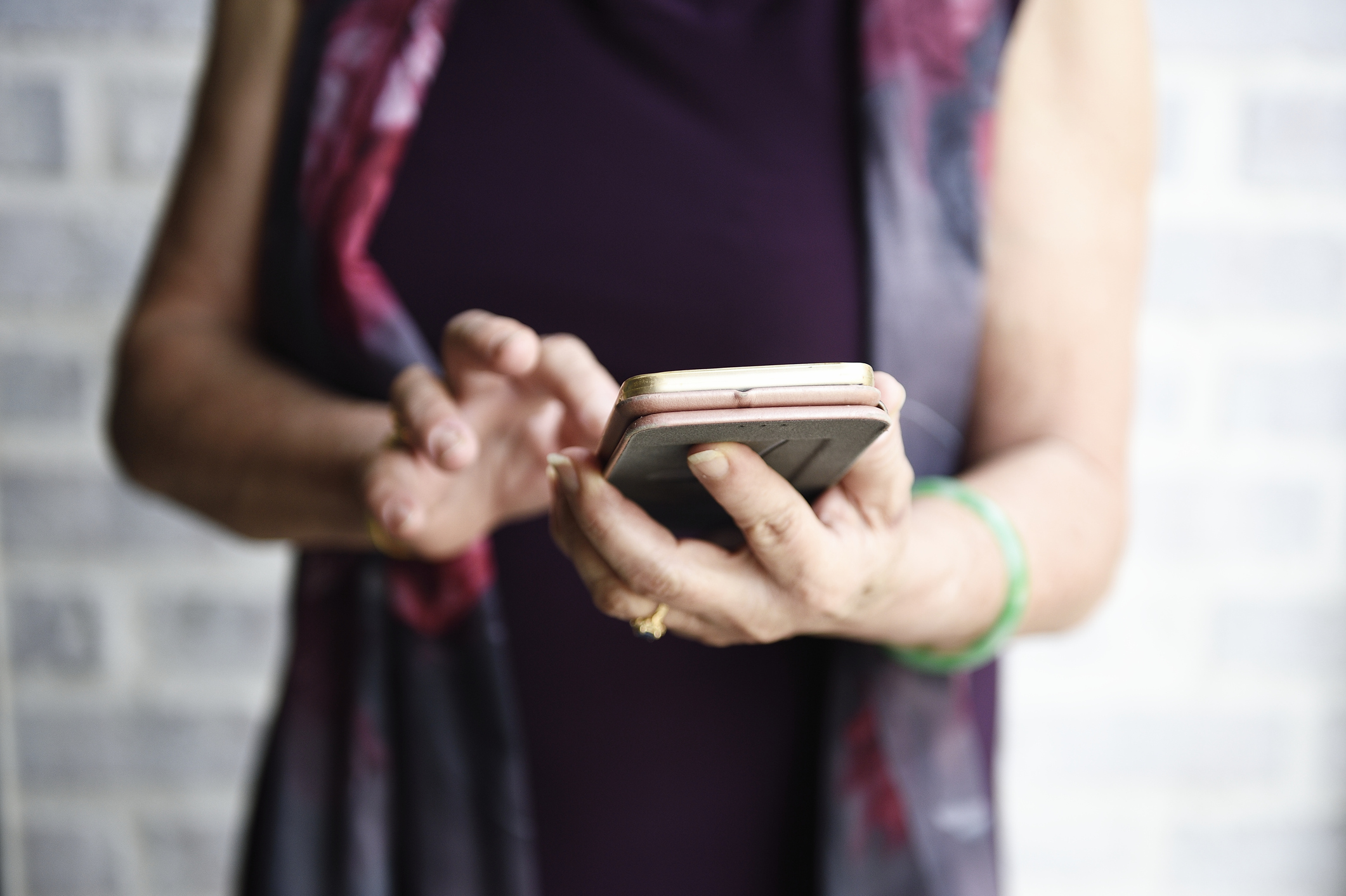 Hands of a senior Chinese lady using a smart phone