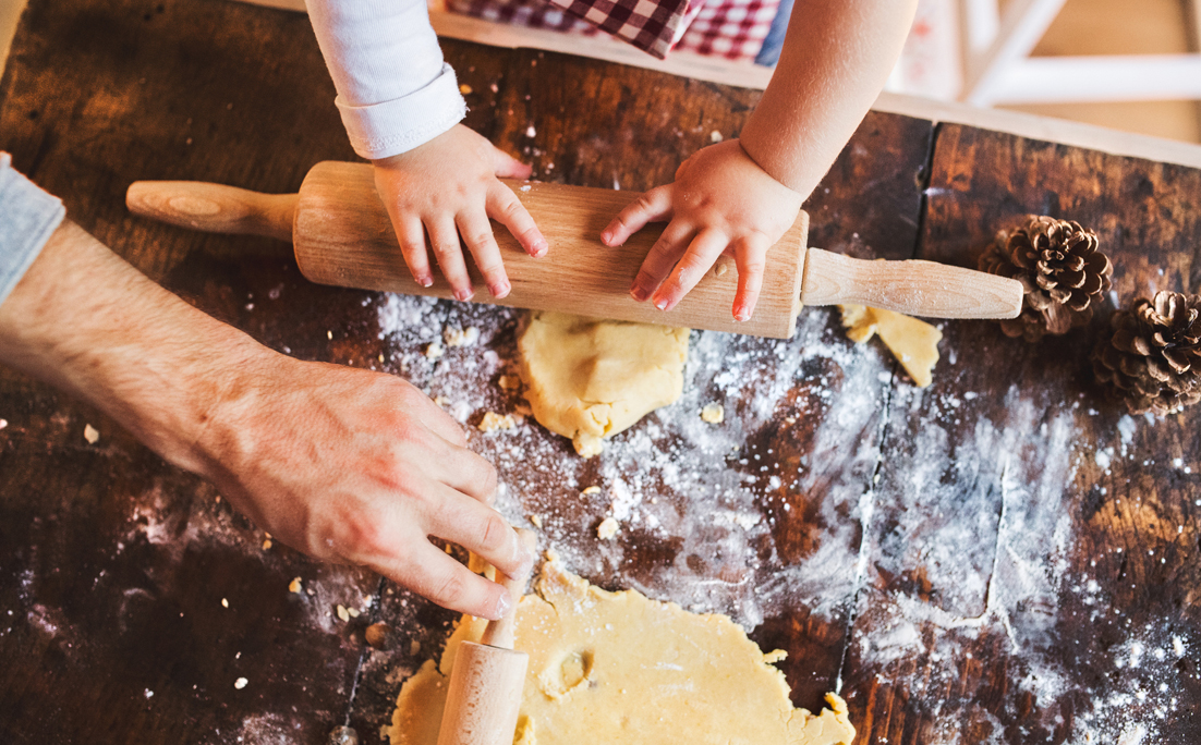 Young family making cookies at home.