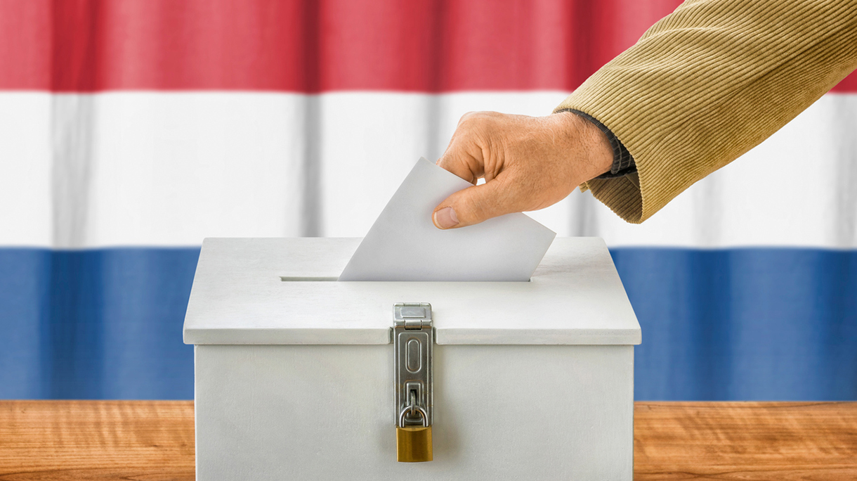 Man putting a ballot into a voting box – Netherlands