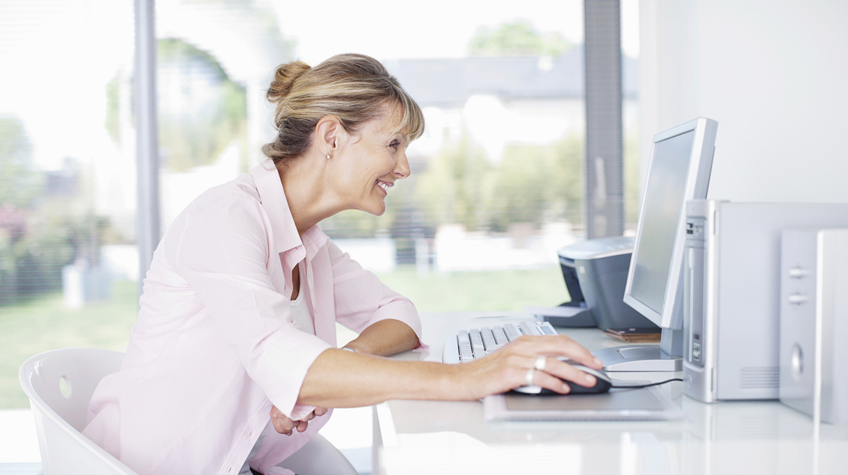 Smiling woman using laptop