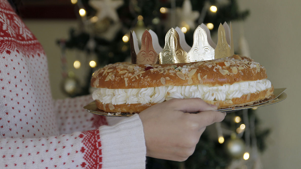 Woman holding Epiphany cake with King Gift