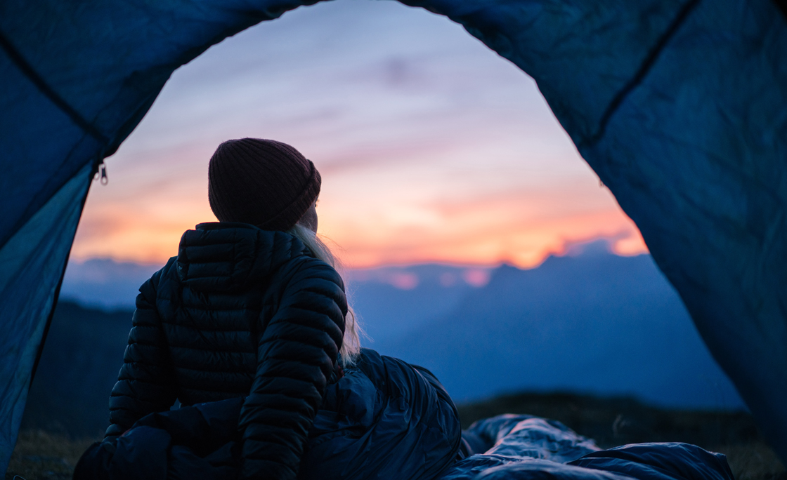 Hiker camps out in high mountain landscape