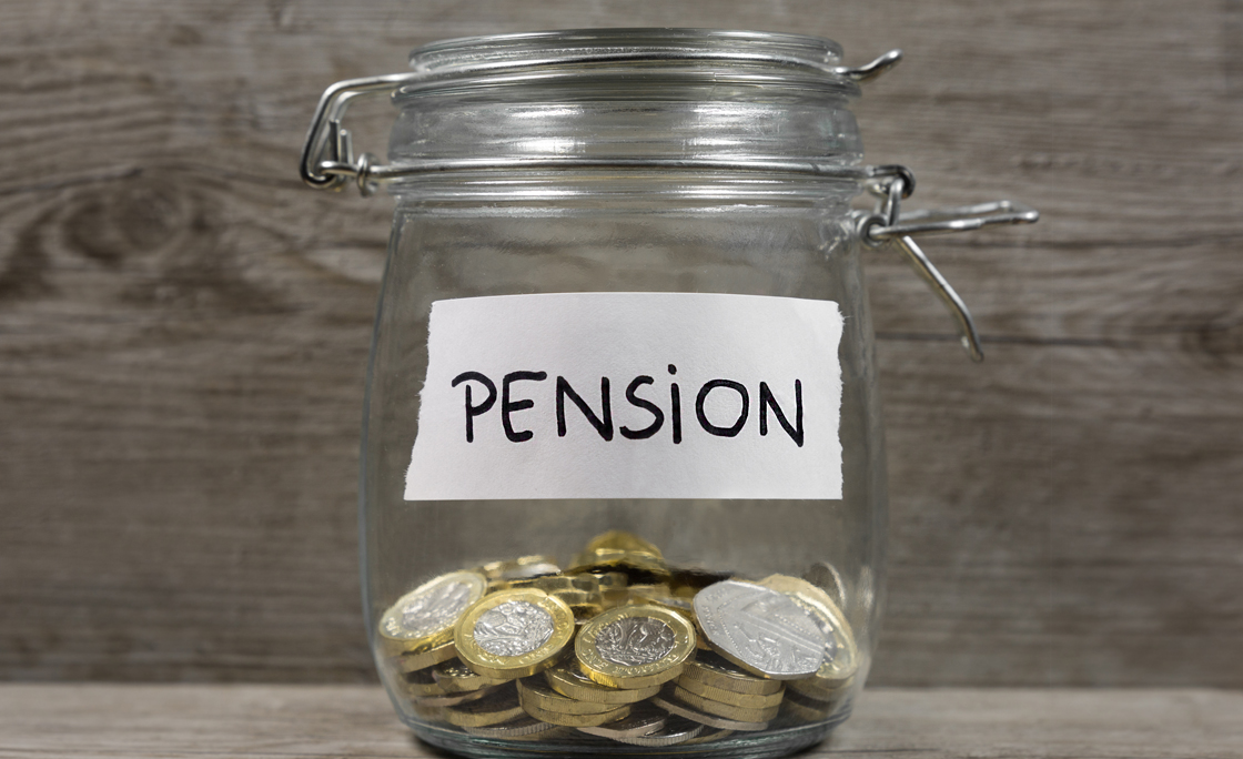 Close-Up Of Coins In Jar On Table