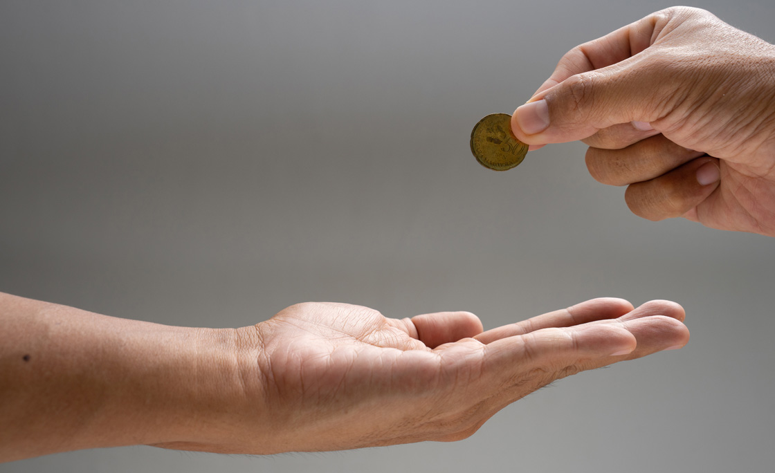 Donation or zakat, hand giving money for helping on close up shot.