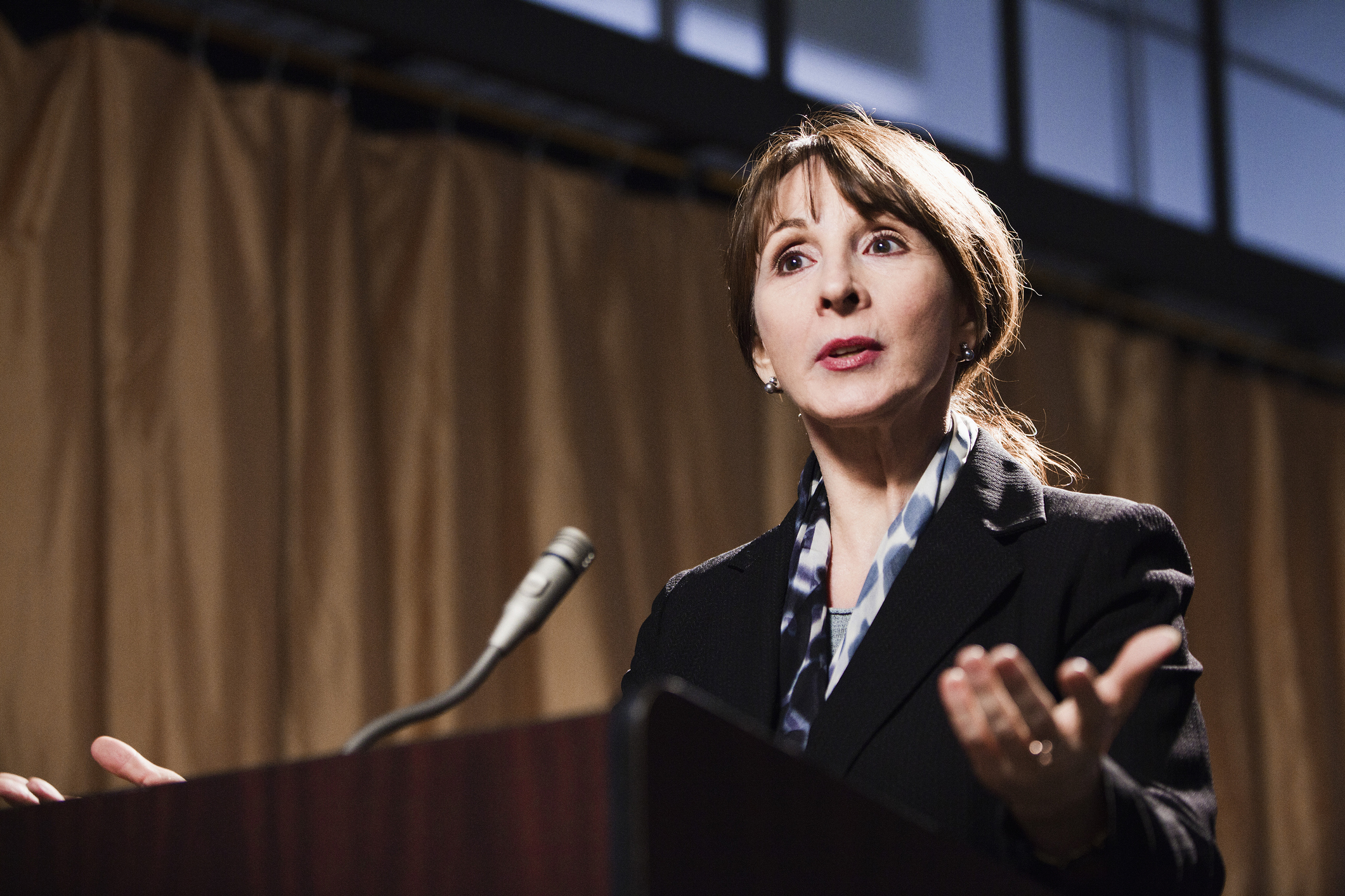 Caucasian businesswoman speaking at podium
